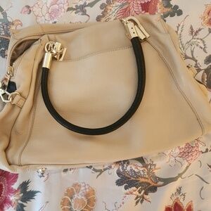 DKNY beige purse with black and gold accents